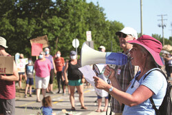 One of the protest's spearheads France Gagnon shouts environmental facts loudly proudly in front of a crowd of hundreds on the afternoon of July 6.