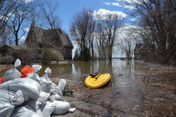 Fraser Road was cut off to residents and help during the floods, with people using water-craft to reach their homes. (LR) Photo: Nicolas Sabourin