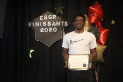 Photo caption: On June 22, l’École secondaire Grande-Rivière held a special ceremony, while following social distancing, celebrating its graduating class of 2020 – which included 302 students. Pictured, Jeremy Souriac smiles as he receives his diploma during the event. Photo: J-D Potié