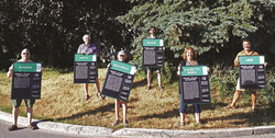 Deschênes residents will be able to learn a little more history about each of their neighbourhood’s streets, thanks to the Deschênes Resident’s Association’s (ARD) latest initiative. Pictured, ARD member Charles Vinet, President Howard Powles, Meganne Bernier Gauld, Jasmin Morin, Lynne Rodier and Maxime Gauld hold up some of the signs before installing them. Photo: Maude Choinard-Boucher.