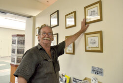 Gary Martineau originals on display at the Bulletin office. He is pictured talking about a demolished historical building that was located along Aylmer Road near Belmont. 
Photo: Lily Ryan