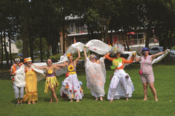 Photo: CyClownes of Good Cheer surprise beach-goers August 3 near the Aylmer Marina.
From left to right: TDAH, Manon des Brumes, Pantoufle, Lady Marianna, Fifi,  Marie La Chouette, Fleur, CyClownes of Good Cheer at Des Cèdres beach spreading smiles. Photo: Amy Mehta