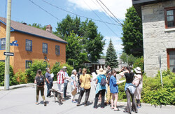 Some participants in the exploratory walk in Old Aylmer organized by the Ville de Gatineau discuss the significance of the neighbourhood’s many heritage homes.