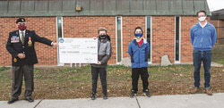 Brady Mondor (student), Hunter Belanger (student) and Mark McDonald (one of the teachers on the Remembrance Day organizing committee) presented the $1,000 to Mr Corriveau.