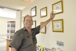 Gary Martineau originals on display at the Bulletin office. He is pictured talking about a demolished historical building that was located along Aylmer Road near Belmont. 
Photo: Lily Ryan