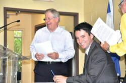 Pontiac MNA André Fortin, seated, announcing funding aid to help the Food Bank buy a more affordable location, August 25.     Photo: William Pryor