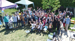 Friends, family and members of the community surround Joshua Alcorn (left) holding Mathis Alcorn on his knee and his partner Roxanne Charbonneau (right) holding Lilianne Alcorn on her knee. 
Photo: Hugh Godman