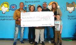 Brazeau Family looks on proudly as Jesse-Blaze presents his grandmother, Carole Deschamp, with a donation for the MS Society of Canada.	Photo: Submitted