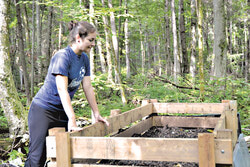 Marie-Hélène Hubert, technician for the Canadian Museum of Nature's (CMN) Vertebrate Collection, turning the soil of the whales compost and looking at the soil's temperature. 
Photo: LRC